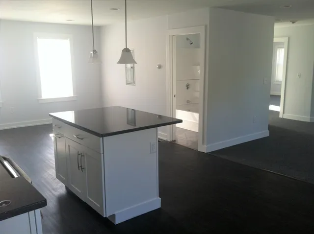 a kitchen with stainless steel appliances granite countertop a sink a stove and a refrigerator