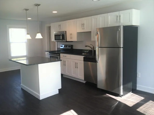 a kitchen with stainless steel appliances a refrigerator stove microwave and sink