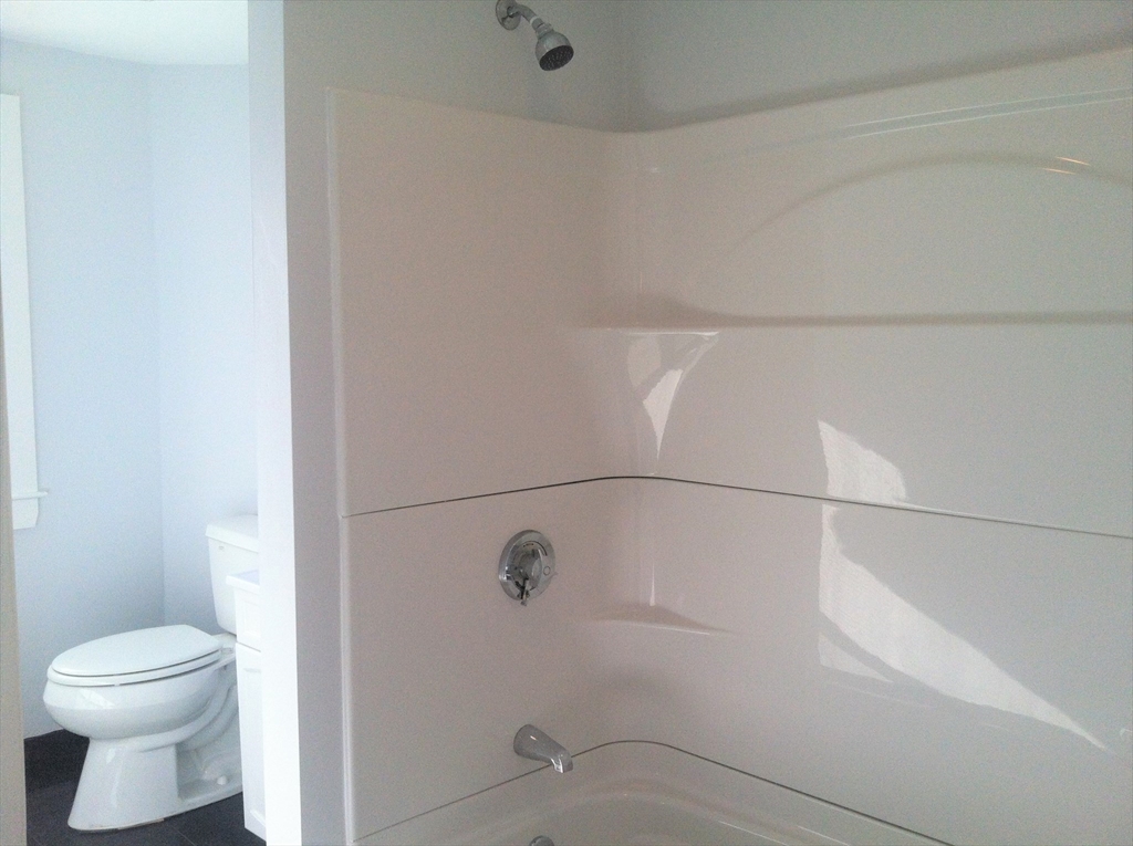 158 Main Street, Unit 2 Wenham, MA 01984 - Photo 8 of 13 a bathroom with a toilet and a shower