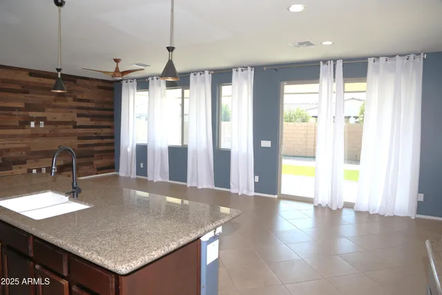 a view of a white house with a small yard