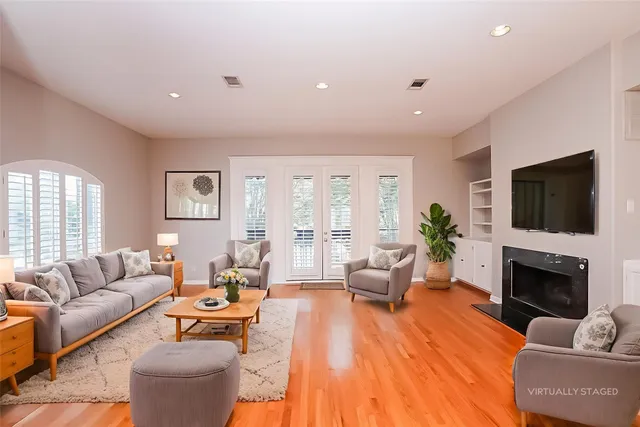 a living room with furniture a flat screen tv and a fireplace