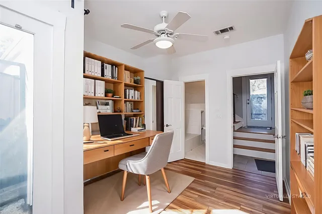 a workspace with wooden floor and furniture
