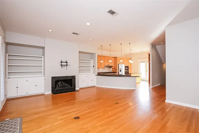 a view of empty room with a fireplace and window