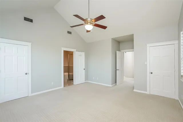 a view of an empty room with a ceiling fan