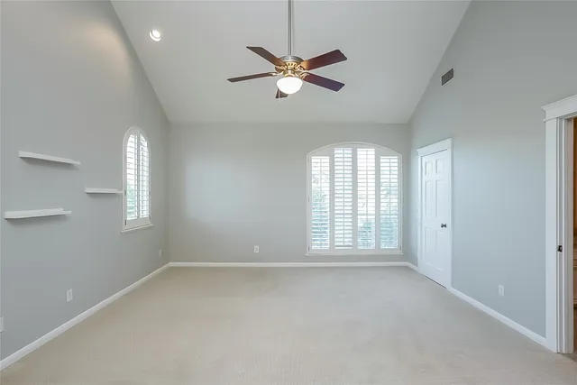 a view of a livingroom with a ceiling fan and window