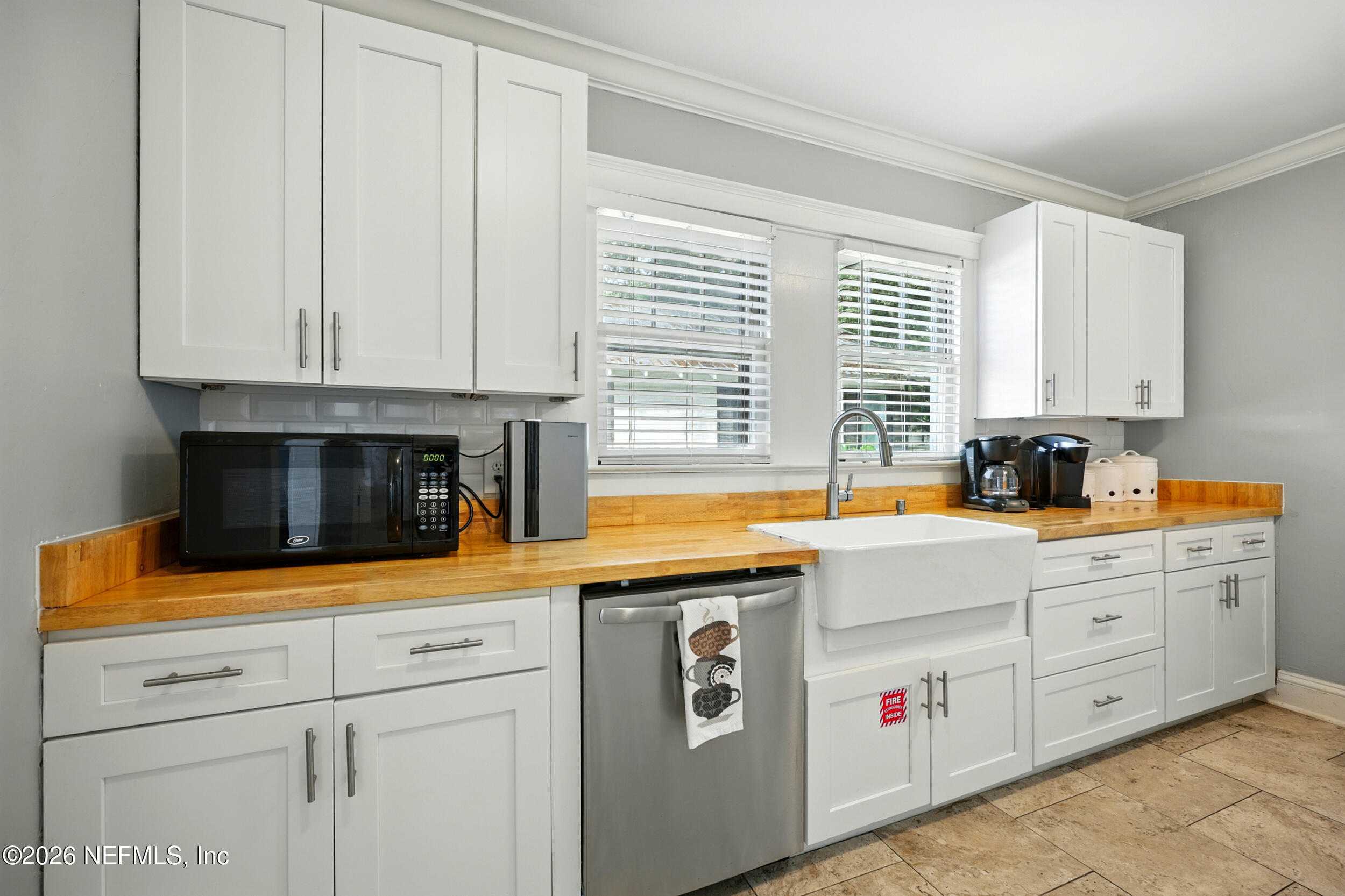22 Marion Street St. Augustine, FL 32084 - Photo 9 of 23 a kitchen with granite countertop white cabinets and white appliances