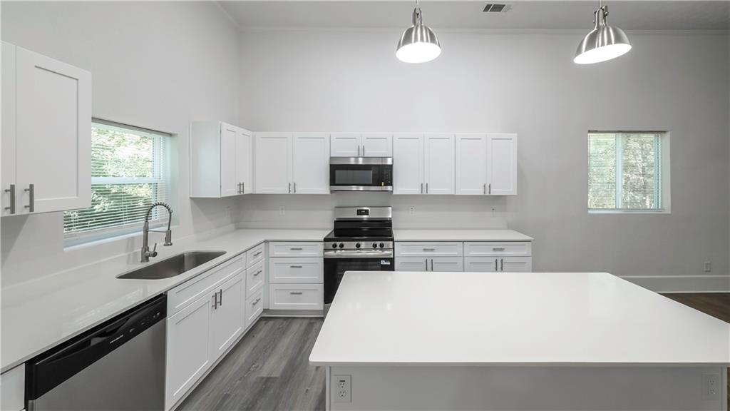 75 Rose Street Tallapoosa, GA 30176 - Photo 11 of 33 a kitchen with a stove a sink and a refrigerator