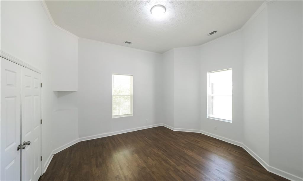 75 Rose Street Tallapoosa, GA 30176 - Photo 19 of 33 an empty room with wooden floor and windows