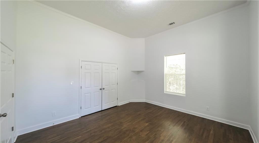 75 Rose Street Tallapoosa, GA 30176 - Photo 21 of 33 an empty room with wooden floor and windows