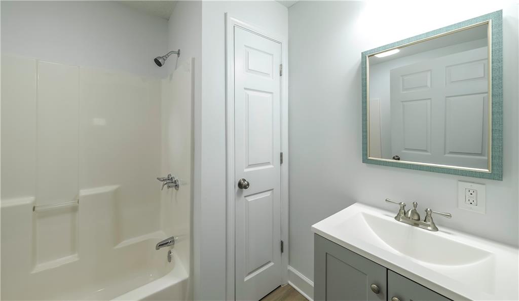 75 Rose Street Tallapoosa, GA 30176 - Photo 22 of 33 a bathroom with a sink and mirror with toilet