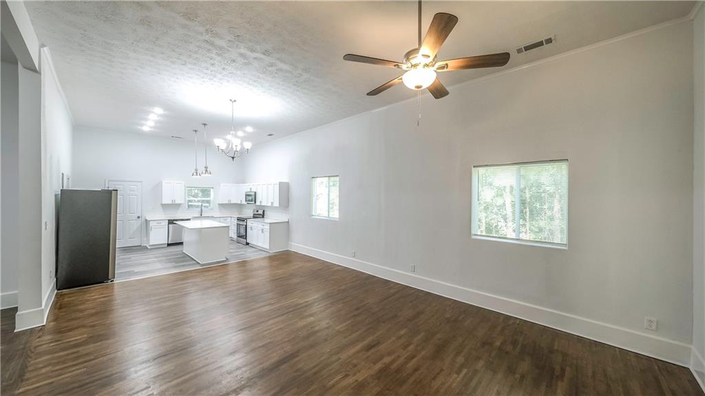 75 Rose Street Tallapoosa, GA 30176 - Photo 4 of 33 a view of a kitchen with kitchen island stainless steel appliances wooden floor and living room view