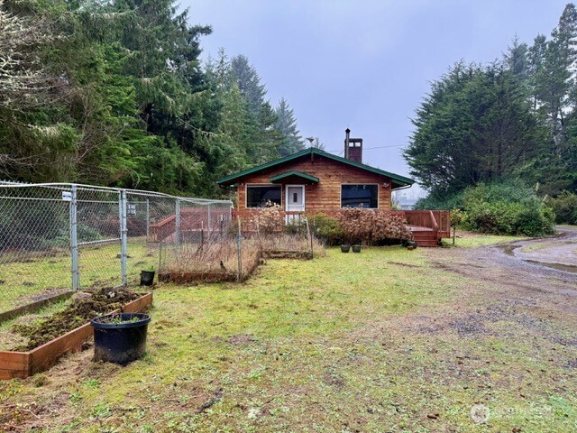 2002 200th Lane Ocean Park, WA 98640 - Photo 21 of 22 a backyard of a house with a garden and barbeque oven