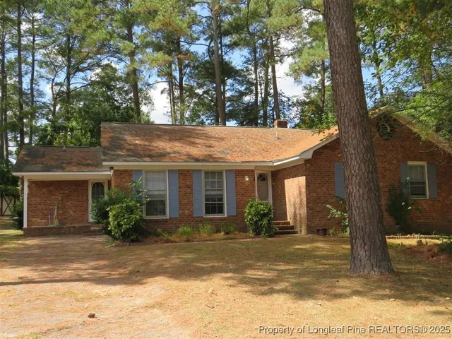 a view of a house with a tree in front