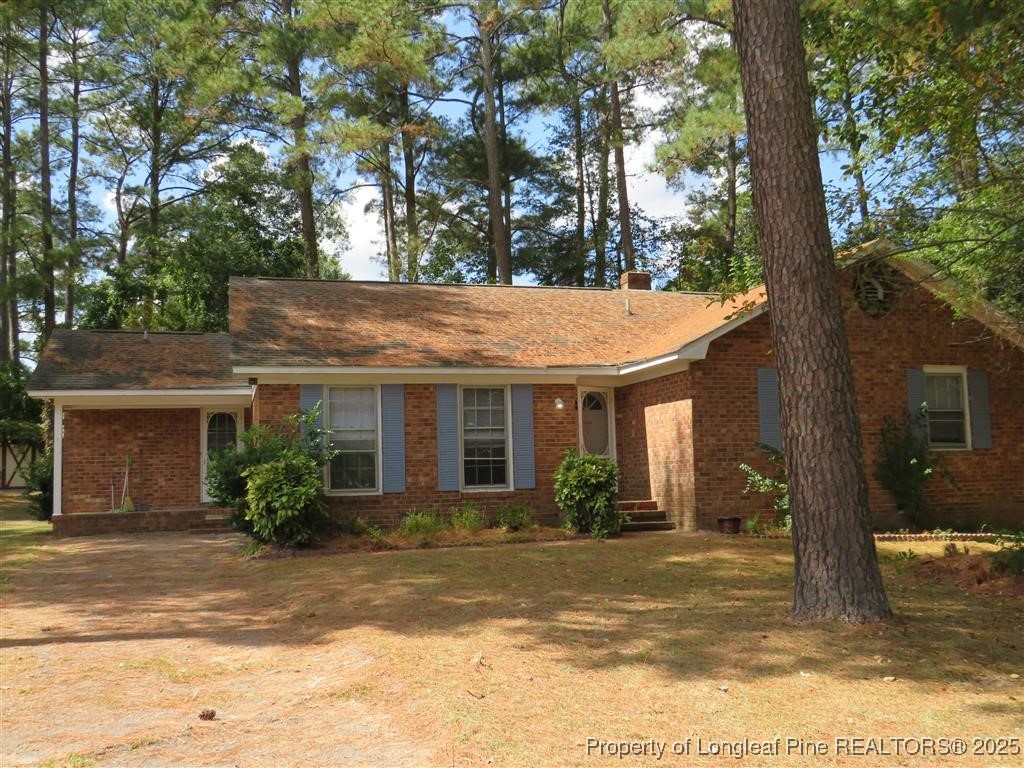 a view of a house with a tree in front