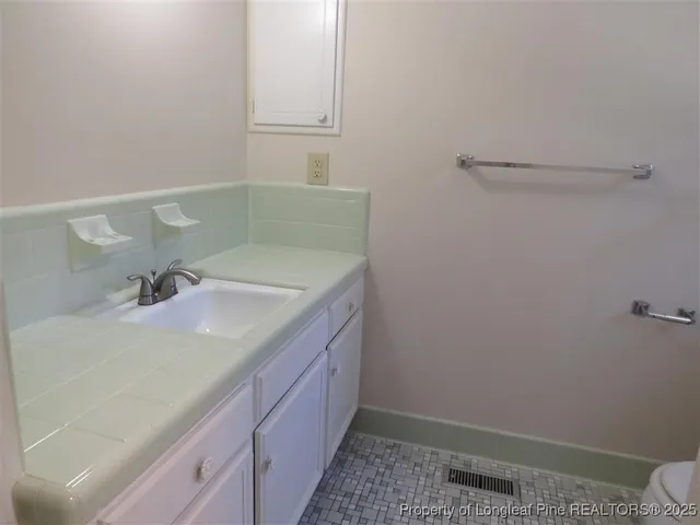 a bathroom with a sink and vanity
