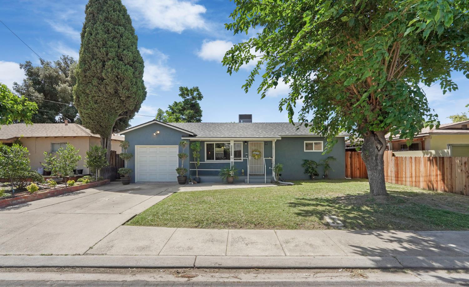 152 Drake Avenue Modesto, CA 95350 - Photo 1 of 52 a front view of a house with a yard and garage
