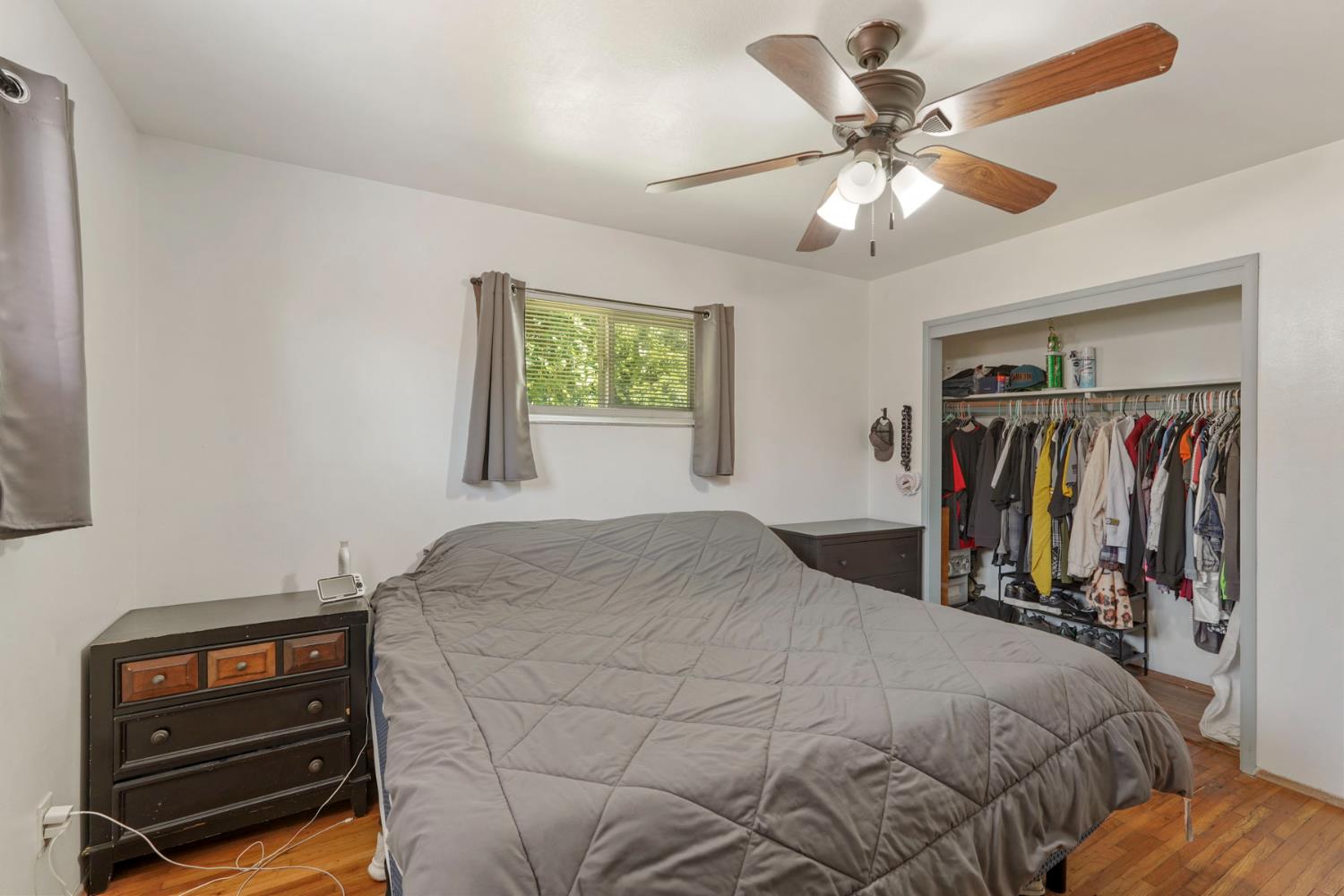152 Drake Avenue Modesto, CA 95350 - Photo 23 of 52 a bedroom with a bed and a chandelier