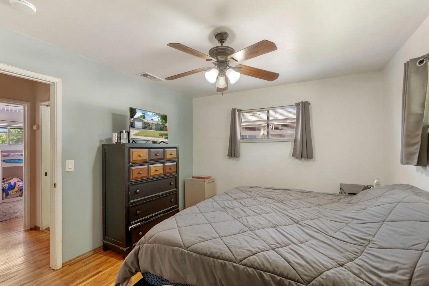 152 Drake Avenue Modesto, CA 95350 - Photo 24 of 52 a bedroom with a bed and wooden floor