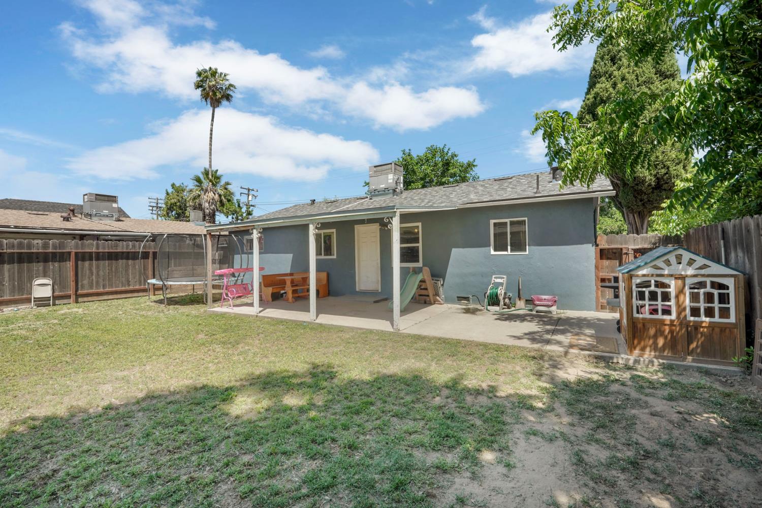 152 Drake Avenue Modesto, CA 95350 - Photo 26 of 52 a front view of house with yard barbeque and outdoor seating