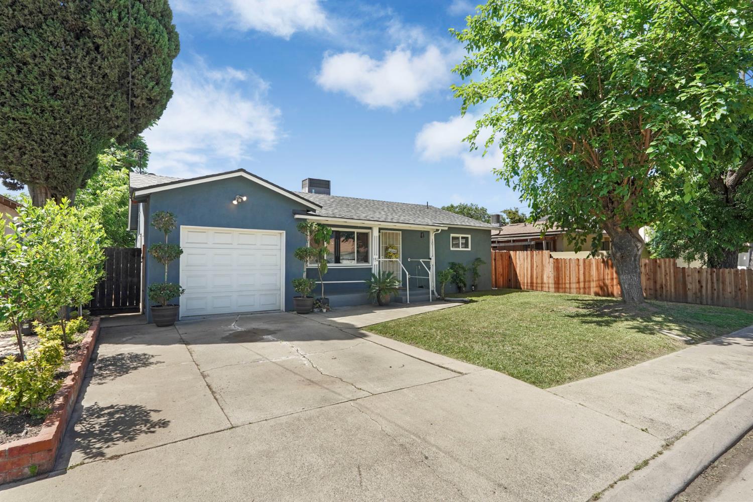 152 Drake Avenue Modesto, CA 95350 - Photo 3 of 52 a front view of a house with a garden