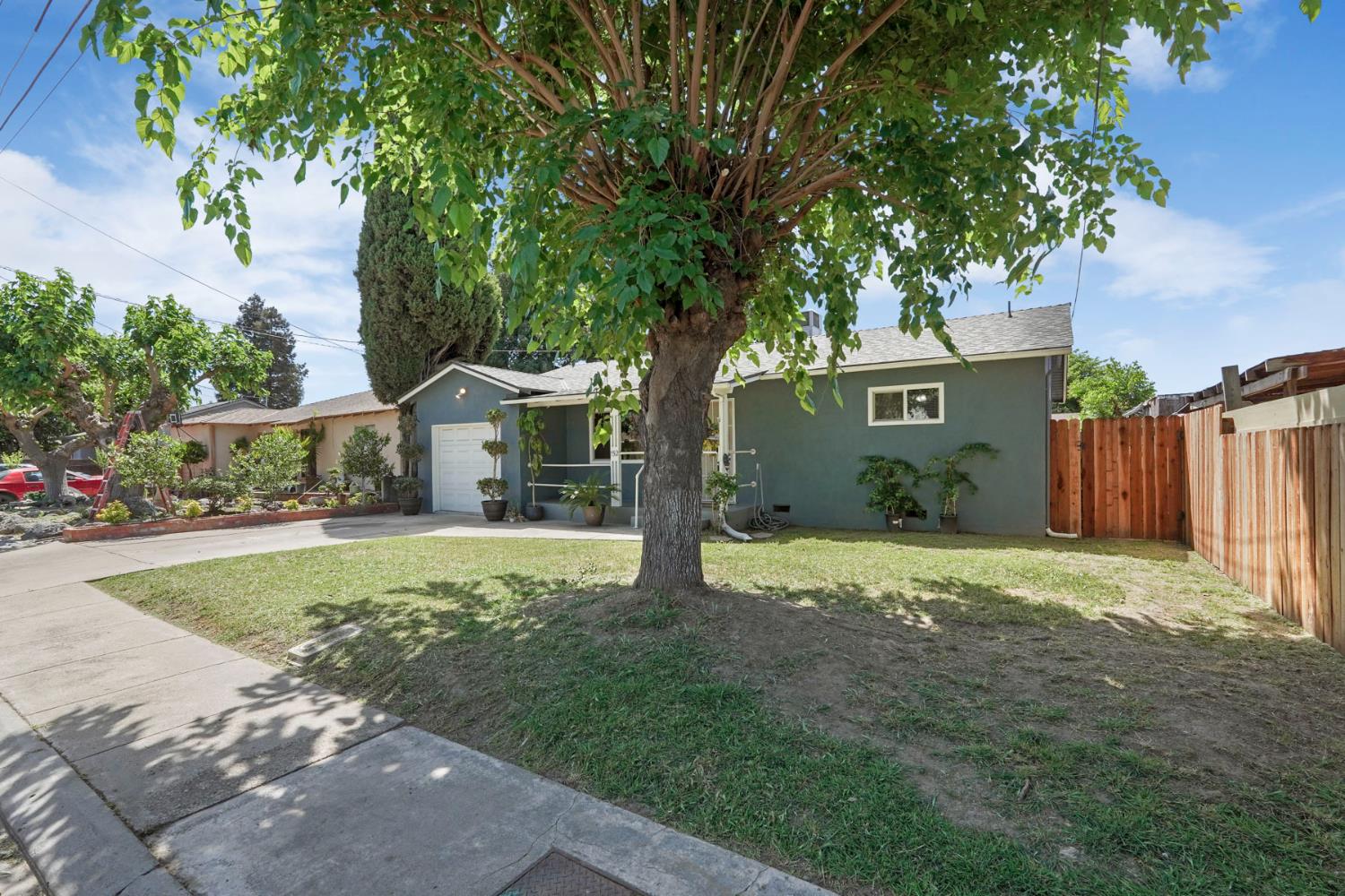 152 Drake Avenue Modesto, CA 95350 - Photo 4 of 52 a front view of a house with a yard and garage