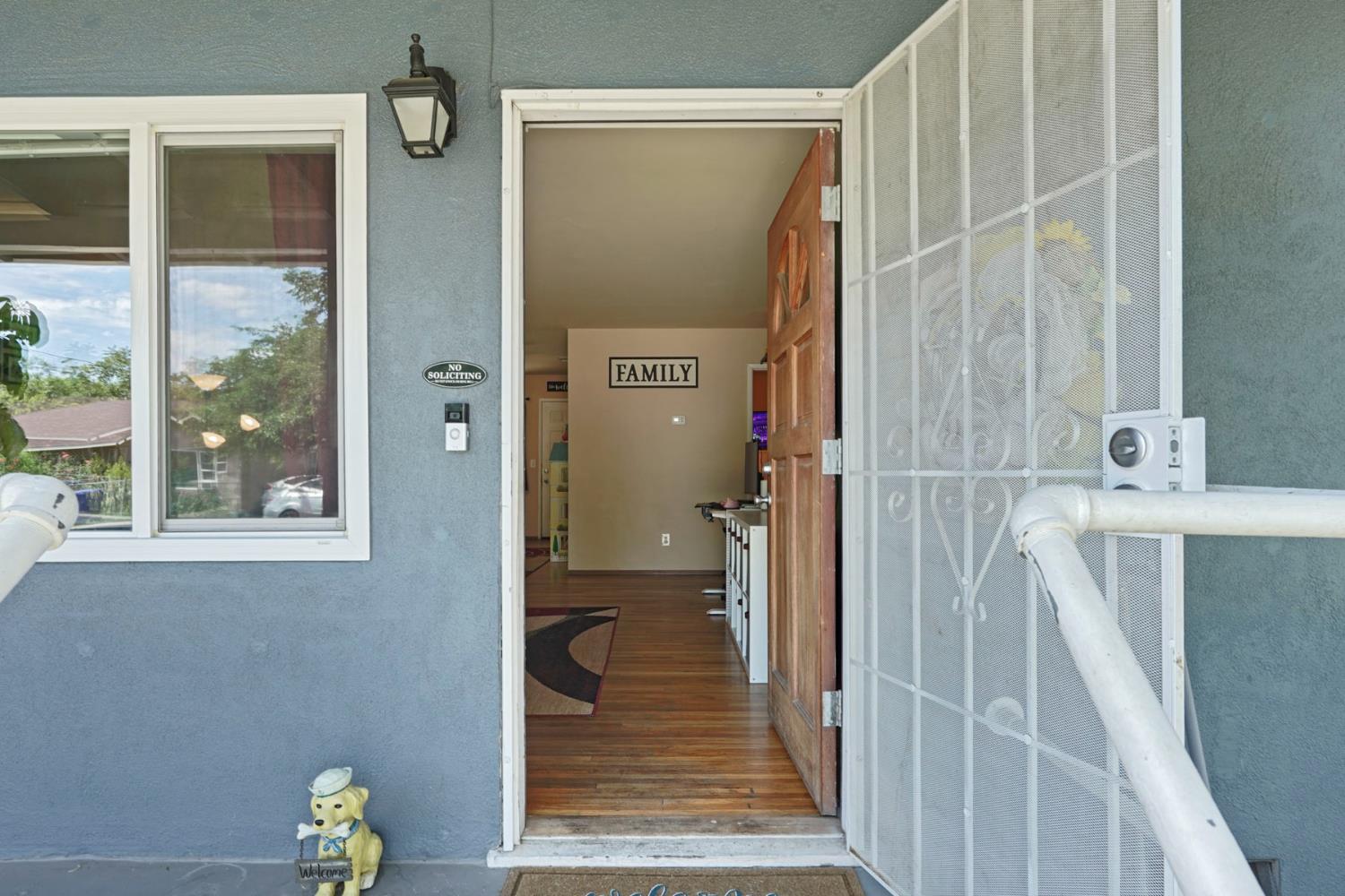 152 Drake Avenue Modesto, CA 95350 - Photo 6 of 52 a view of a hallway with wooden floor and a bathroom