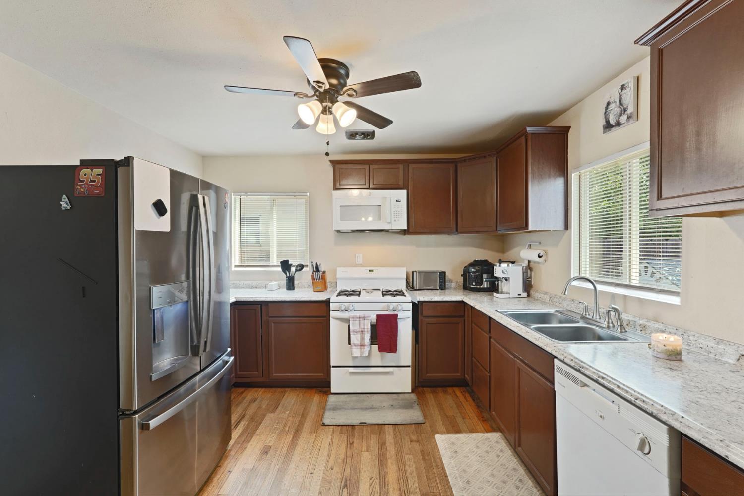 152 Drake Avenue Modesto, CA 95350 - Photo 7 of 52 a kitchen with stainless steel appliances a sink stove and refrigerator