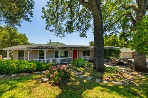 a front view of a house with a garden