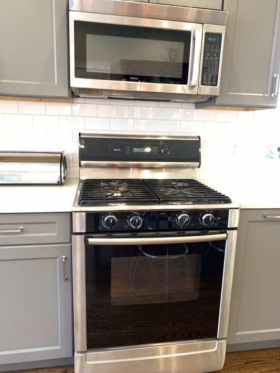 93 Waldeck Road Milton, MA 02186 - Photo 23 of 30 a stove top oven sitting inside of a kitchen