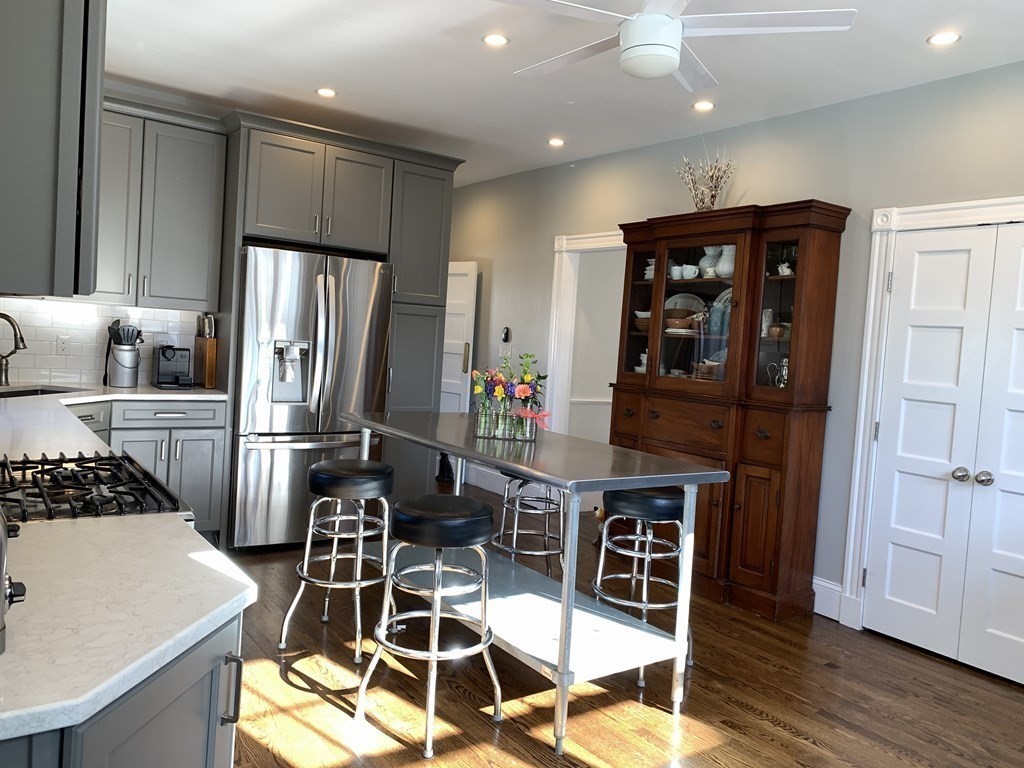 93 Waldeck Road Milton, MA 02186 - Photo 4 of 30 a kitchen with stainless steel appliances a refrigerator and a stove top oven
