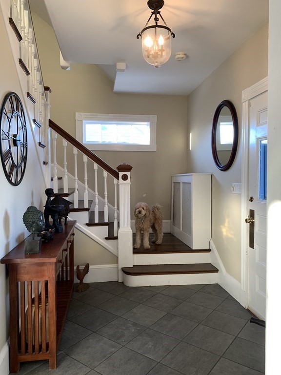 93 Waldeck Road Milton, MA 02186 - Photo 7 of 30 a view of a hallway with wooden floor and entryway
