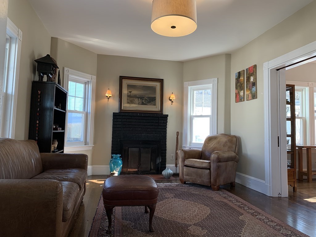 93 Waldeck Road Milton, MA 02186 - Photo 8 of 30 a living room with furniture and a fireplace