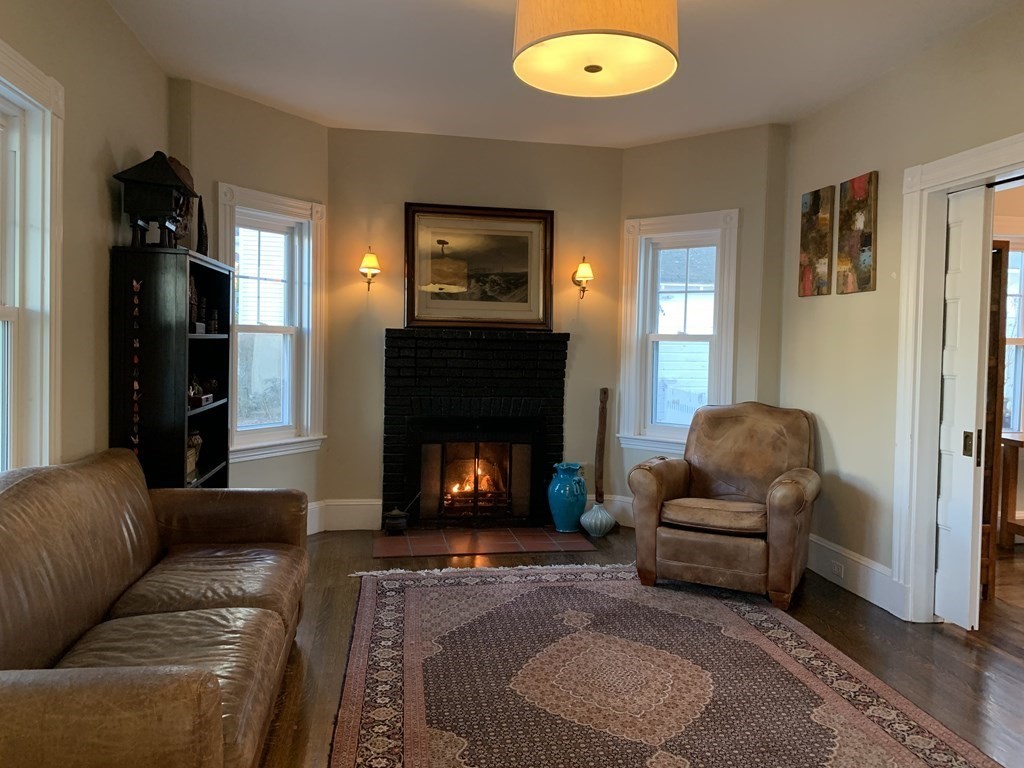 93 Waldeck Road Milton, MA 02186 - Photo 9 of 30 a living room with furniture and a fireplace