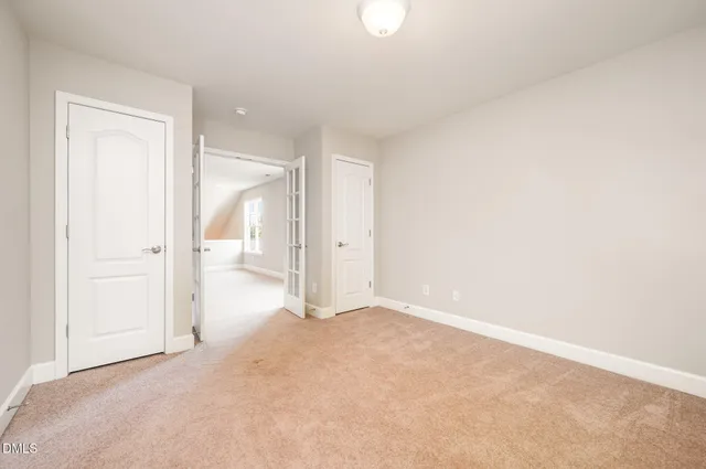 a view of an empty room with a ceiling fan