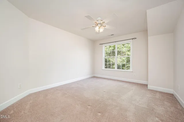 a view of a porch with wooden floor and fence