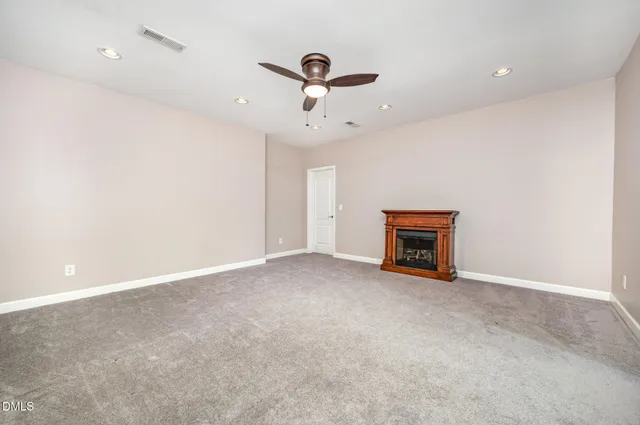 a view of a chair and table in backyard of the house