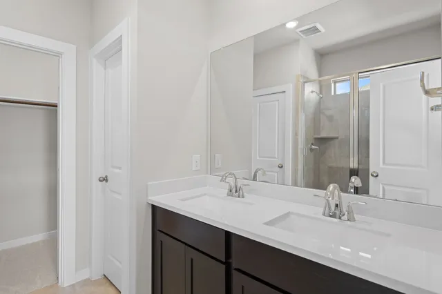 a bathroom with 2 sink and a mirror