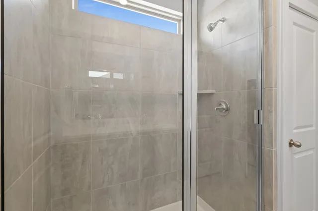 a bathroom with a glass shower door