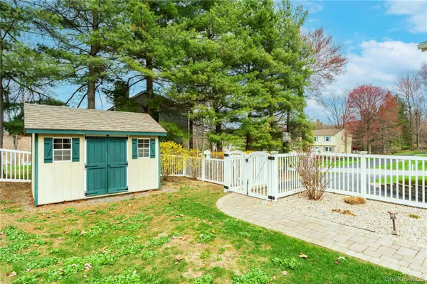 a view of a patio with table and chairs with wooden floor and fence