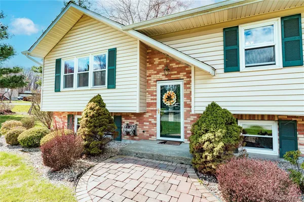 a front view of a house with garden