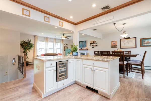 a kitchen with granite countertop kitchen island sink stove and refrigerator