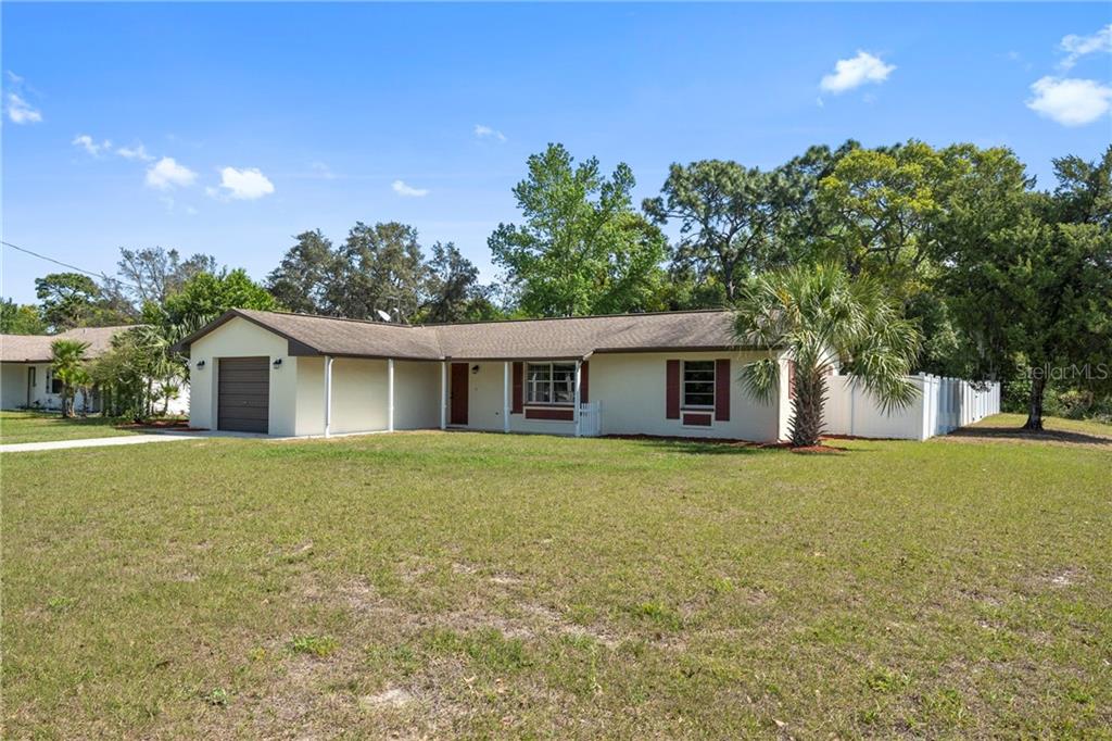 5550 Pillar Avenue Spring Hill, FL 34608 - Photo 1 of 1 a front view of house with yard and trees