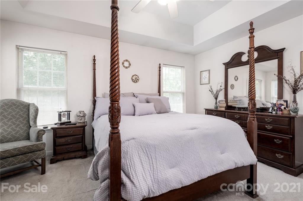 2331 Pimpernel Road Charlotte, NC 28213 - Photo 16 of 30 a bedroom with a bed a couch and dresser
