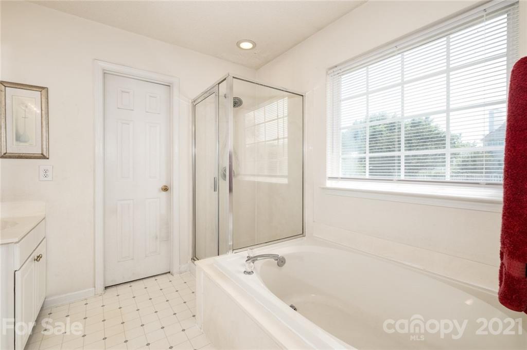 2331 Pimpernel Road Charlotte, NC 28213 - Photo 18 of 30 a bathroom with a bathtub and a shower