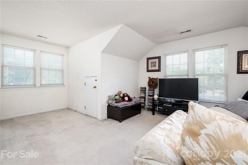2331 Pimpernel Road Charlotte, NC 28213 - Photo 20 of 30 a bedroom with bed and flat screen tv