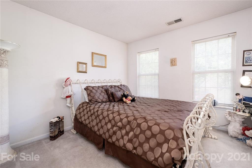 2331 Pimpernel Road Charlotte, NC 28213 - Photo 22 of 30 a bedroom with a bed and a window