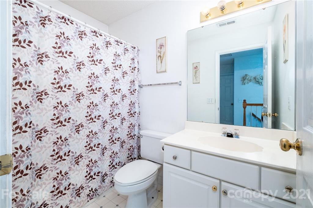 2331 Pimpernel Road Charlotte, NC 28213 - Photo 25 of 30 a bathroom with a sink toilet and shower