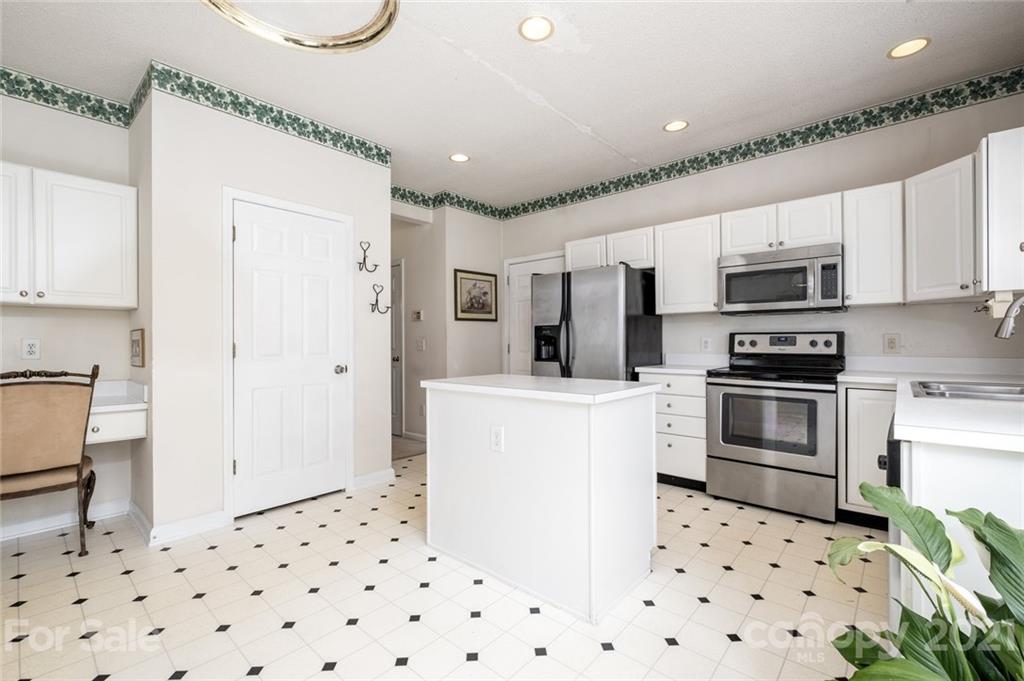 2331 Pimpernel Road Charlotte, NC 28213 - Photo 5 of 30 a kitchen with granite countertop a refrigerator and a stove top oven