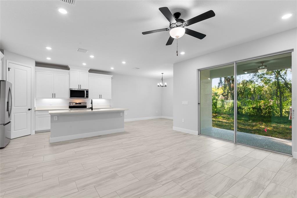 371 Miller Road Sanford, FL 32773 - Photo 17 of 50 a view of kitchen with stainless steel appliances kitchen island granite countertop a stove and a refrigerator