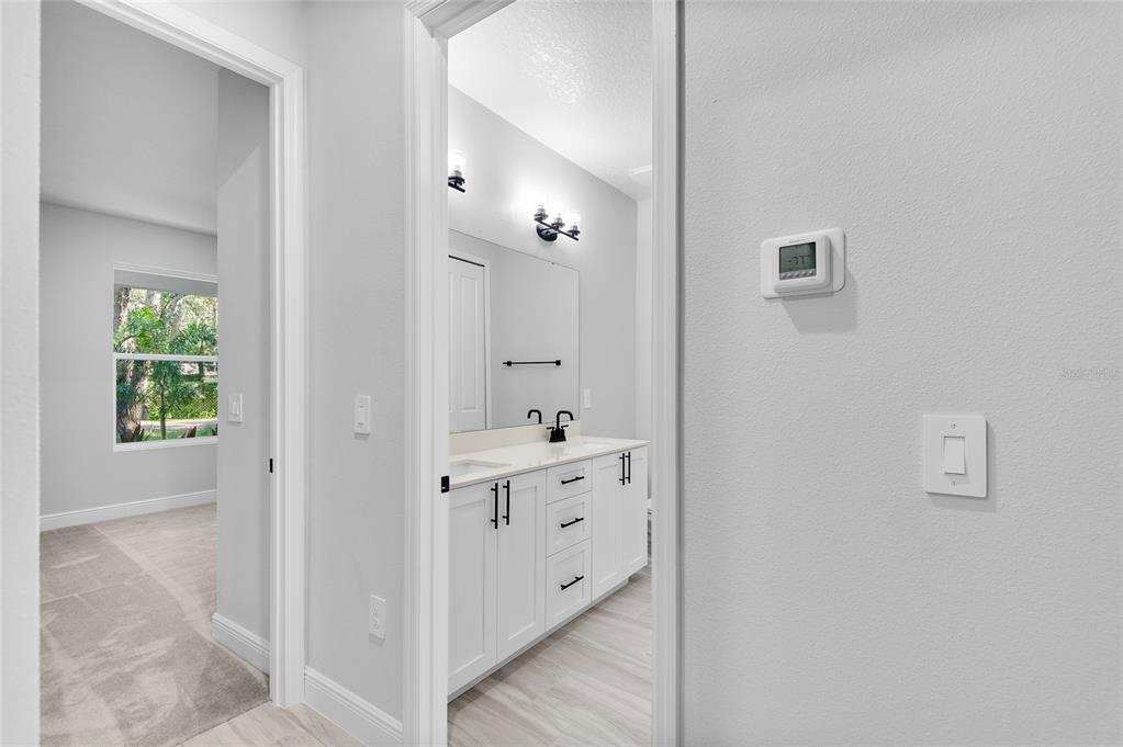 371 Miller Road Sanford, FL 32773 - Photo 26 of 50 a bathroom with a double vanity sink and mirror with shower